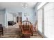 Bright dining room with wood table and a view of living area through an arched doorway at 805 Harvest Lake Dr, Brownsburg, IN 46112