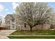 Attractive two-story brick home with well-maintained lawn and a large, blooming tree in the front yard at 805 Harvest Lake Dr, Brownsburg, IN 46112
