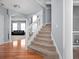 Inviting foyer with hardwood floors, a carpeted staircase, and views of the living room beyond at 805 Harvest Lake Dr, Brownsburg, IN 46112