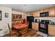 Eat-in kitchen featuring a dining table, black appliances, and wooden cabinets at 805 Harvest Lake Dr, Brownsburg, IN 46112