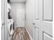 Functional laundry room with modern washer and dryer, ample storage, and stylish flooring at 805 Harvest Lake Dr, Brownsburg, IN 46112