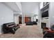 Spacious living room with high ceilings, fireplace, built-in shelving, and plush carpeting at 805 Harvest Lake Dr, Brownsburg, IN 46112