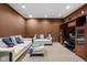 Inviting living room features plush seating, neutral carpet, and built in wooden shelving at 805 Harvest Lake Dr, Brownsburg, IN 46112