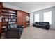 Comfortable living room featuring built-in bookshelves, plush carpeting, and ample seating at 805 Harvest Lake Dr, Brownsburg, IN 46112