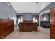 Large main bedroom featuring a wooden bed frame, wood dresser, and a comfortable seating area at 805 Harvest Lake Dr, Brownsburg, IN 46112