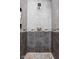 Stylish tiled shower with mosaic accents, a modern shower head, and built-in shelving niche at 805 Harvest Lake Dr, Brownsburg, IN 46112