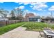 Backyard featuring a grassy lawn, a wooden fence, a detached garage, and a patio at 827 E Minnesota St, Indianapolis, IN 46203