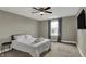 Comfortable bedroom featuring a large window, ceiling fan, and soft carpeted floor at 827 E Minnesota St, Indianapolis, IN 46203