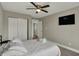 Comfortable bedroom featuring a ceiling fan, closet and soft carpeted floor at 827 E Minnesota St, Indianapolis, IN 46203