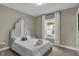 Cozy bedroom features natural light and a stylish headboard at 827 E Minnesota St, Indianapolis, IN 46203