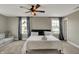 Spacious bedroom featuring a ceiling fan, sitting area, and two windows for natural light at 827 E Minnesota St, Indianapolis, IN 46203