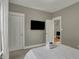 Comfortable bedroom featuring a large window, TV, closet and soft carpeted floor at 827 E Minnesota St, Indianapolis, IN 46203
