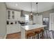 Bright kitchen boasts stainless appliances, center island with breakfast bar, and modern lighting at 827 E Minnesota St, Indianapolis, IN 46203