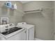 Functional laundry room with a washer, dryer, and wire shelving for convenient storage at 827 E Minnesota St, Indianapolis, IN 46203