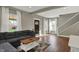 Bright living room with a gray sofa, hardwood floors, and ample natural light at 827 E Minnesota St, Indianapolis, IN 46203