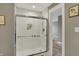 Clean shower features white tile, glass door, built in storage, and modern fixtures at 827 E Minnesota St, Indianapolis, IN 46203