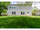 Home's spacious backyard with a lush green lawn, perfect for outdoor activities and relaxation at 8404 Alcona Dr, Indianapolis, IN 46237