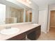 Bathroom featuring double sinks, a large mirror, and a glass enclosed shower at 8404 Alcona Dr, Indianapolis, IN 46237