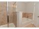 Bathroom featuring a walk-in shower and a soaking tub with tile surround at 8404 Alcona Dr, Indianapolis, IN 46237
