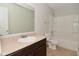 Bathroom features a single sink vanity, a toilet, and a bathtub with shower at 8404 Alcona Dr, Indianapolis, IN 46237
