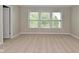 Spacious bedroom with three windows and neutral carpet at 8404 Alcona Dr, Indianapolis, IN 46237