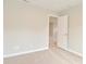 Bedroom with neutral walls, plush carpet, and an open doorway into another room at 8404 Alcona Dr, Indianapolis, IN 46237