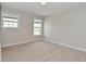 Bright bedroom with neutral walls, plush carpet, and natural light from two windows at 8404 Alcona Dr, Indianapolis, IN 46237