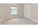 Cozy bedroom with neutral walls, soft carpet, a window, and a closet at 8404 Alcona Dr, Indianapolis, IN 46237