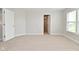 Bedroom with neutral carpet, an open doorway and a window at 8404 Alcona Dr, Indianapolis, IN 46237