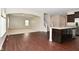 Modern open concept kitchen featuring stainless steel appliances, an island, and hardwood floors that flow through the home at 8404 Alcona Dr, Indianapolis, IN 46237