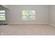 Bright living room featuring neutral walls, carpet flooring, and natural light through the windows at 8404 Alcona Dr, Indianapolis, IN 46237