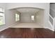 Open concept living room featuring neutral walls, carpet and wood floors, and an archway to the next room at 8404 Alcona Dr, Indianapolis, IN 46237