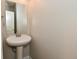 A pedestal sink is featured in this well-lit powder room at 8404 Alcona Dr, Indianapolis, IN 46237