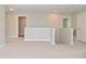 Upstairs landing with neutral walls, plush carpet, and doorways to other rooms at 8404 Alcona Dr, Indianapolis, IN 46237
