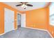 A bedroom featuring gray carpet, ceiling fan, and connected to a hallway and closet at 846 Sunchaser Rd, Lebanon, IN 46052