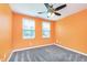 Bedroom features gray carpet, ceiling fan, and natural light from two windows at 846 Sunchaser Rd, Lebanon, IN 46052