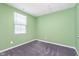 A brightly painted bedroom with a window and modern gray carpet at 846 Sunchaser Rd, Lebanon, IN 46052