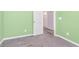A bedroom featuring gray carpet, white trim, and a view into the entryway at 846 Sunchaser Rd, Lebanon, IN 46052