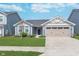 Charming single-story home featuring a light blue exterior, well-manicured lawn, and a two-car garage at 846 Sunchaser Rd, Lebanon, IN 46052
