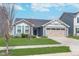 Attractive single-Gathering home with a blue exterior, a green lawn, and an attached two-car garage at 846 Sunchaser Rd, Lebanon, IN 46052