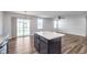 Open kitchen and living area featuring granite countertops and sliding glass doors at 846 Sunchaser Rd, Lebanon, IN 46052