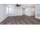 Open-concept living room with luxury vinyl plank flooring, neutral walls, modern fan, and bright natural light at 846 Sunchaser Rd, Lebanon, IN 46052