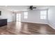 Spacious open-concept living room with luxury vinyl plank flooring, abundant natural light, and ceiling fan at 846 Sunchaser Rd, Lebanon, IN 46052