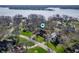 Aerial view of a neighborhood with lush green trees, lake, and beautiful homes at 9111 Sand Key Ln, Indianapolis, IN 46256