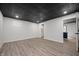 Spacious basement with gray flooring and unique black ceiling, ready for customization at 9111 Sand Key Ln, Indianapolis, IN 46256