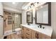 Modern bathroom with double sink vanity, stylish mirrors, and a glass-enclosed shower with sleek fixtures at 9111 Sand Key Ln, Indianapolis, IN 46256