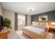 Well-lit bedroom with a bed, a nightstand on either side, and modern fixtures, creating a cozy and inviting space at 9111 Sand Key Ln, Indianapolis, IN 46256