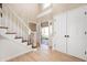 Grand foyer with hardwood floors, staircase, and natural light streaming through the front door at 9111 Sand Key Ln, Indianapolis, IN 46256