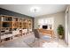 Home office with built-in shelving, a spacious desk, neutral walls, and ample natural light from a window at 9111 Sand Key Ln, Indianapolis, IN 46256