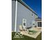 Exterior of home with light blue siding, patio, and outdoor seating with a tidy lawn at 9851 Pica Dr, Fishers, IN 46040